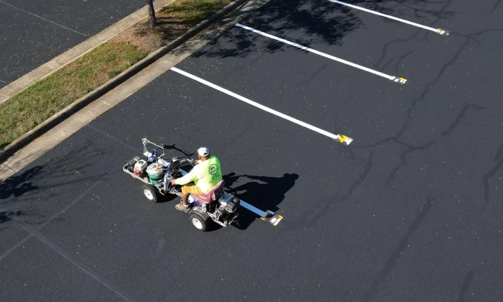 fresh-asphalt-parking-lot-linestriping-crew-at-work